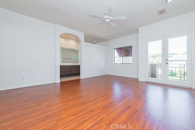 spare room featuring ceiling fan, hardwood / wood-style floors, and french doors