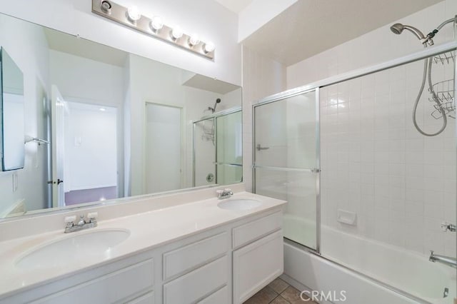 bathroom with shower / bath combination with glass door, vanity, and tile patterned flooring