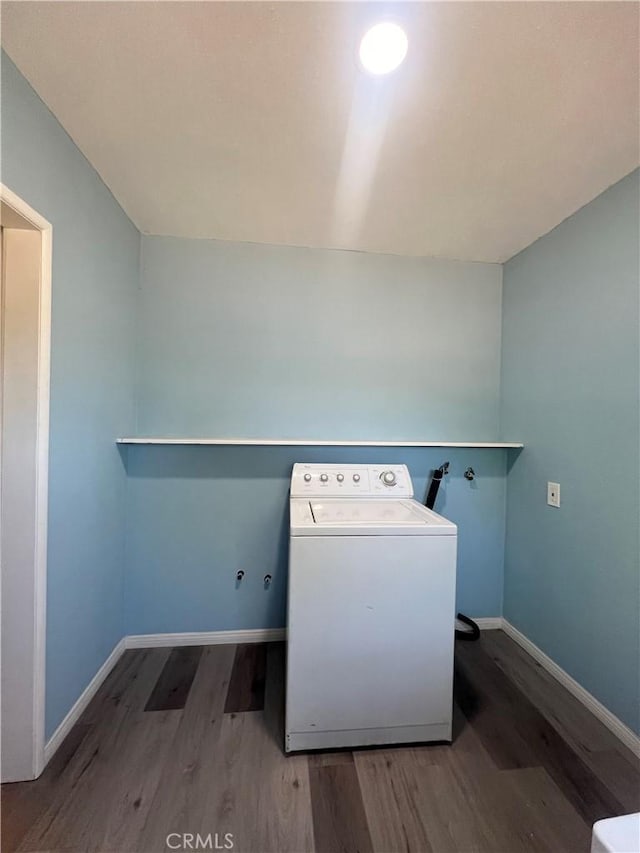 laundry area featuring dark wood-type flooring and washer / dryer