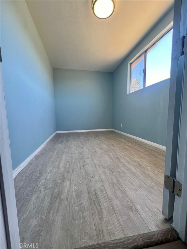 unfurnished room with hardwood / wood-style floors