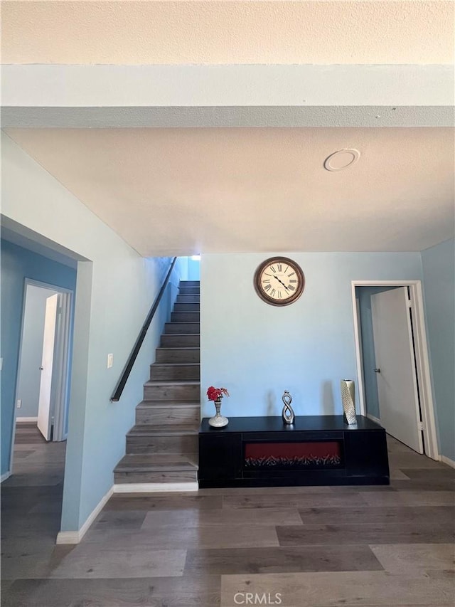 staircase with wood-type flooring