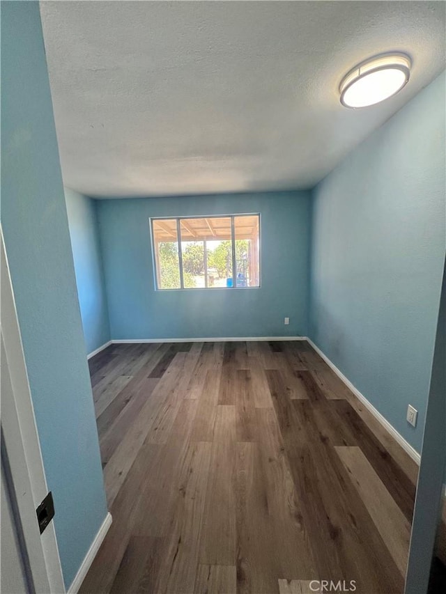 empty room with wood-type flooring