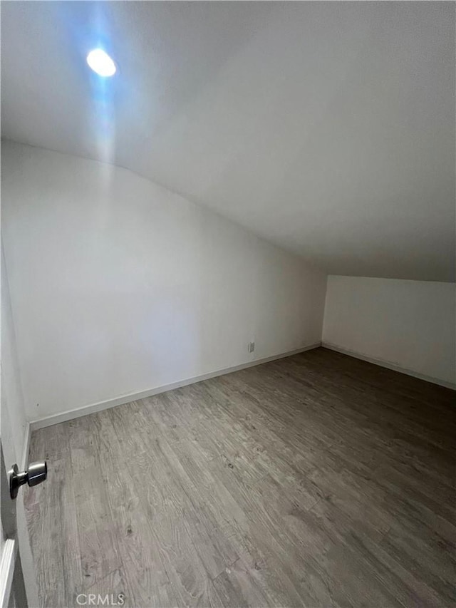 bonus room with vaulted ceiling and hardwood / wood-style floors