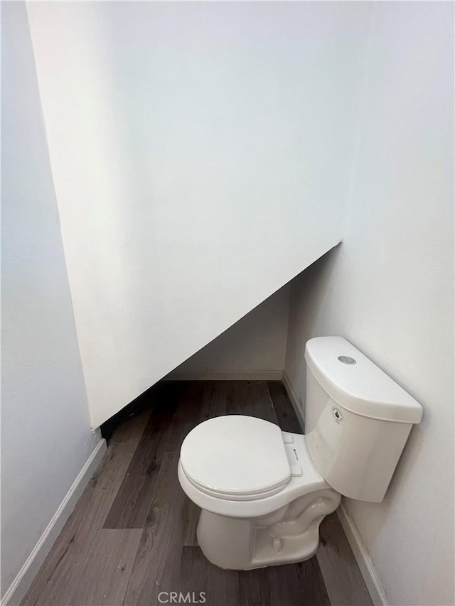 bathroom featuring toilet and hardwood / wood-style flooring