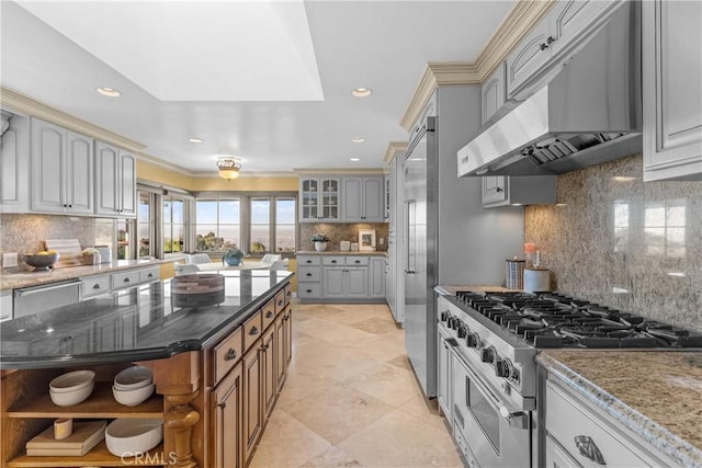 kitchen with tasteful backsplash, premium appliances, and dark stone counters