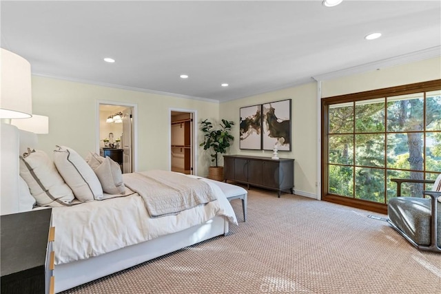 bedroom with carpet, ensuite bathroom, ornamental molding, a walk in closet, and a closet