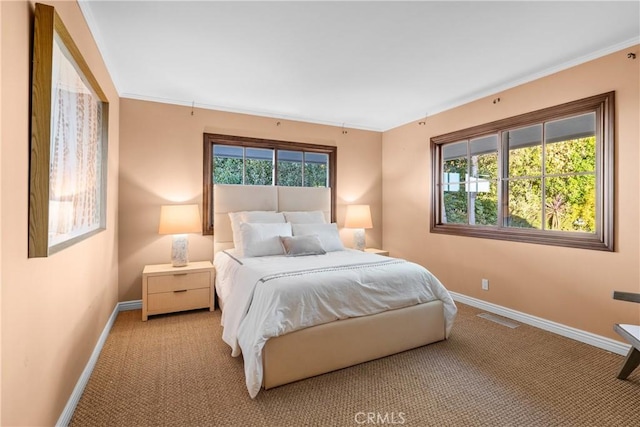 carpeted bedroom featuring ornamental molding