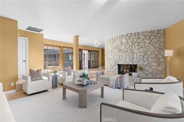 living room with a stone fireplace