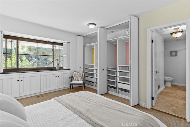 bedroom with ensuite bathroom and a closet