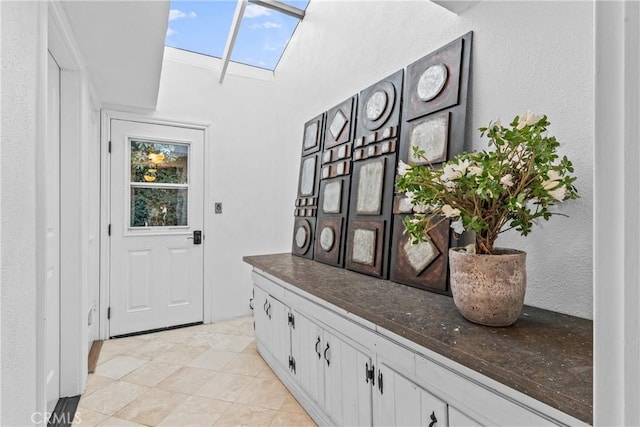 doorway to outside with a skylight