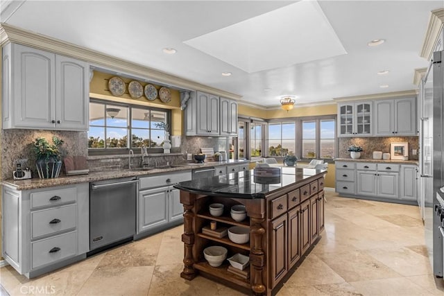 kitchen with a kitchen island, gray cabinetry, and stainless steel dishwasher