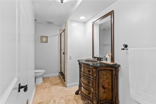 bathroom with toilet, walk in shower, and vanity