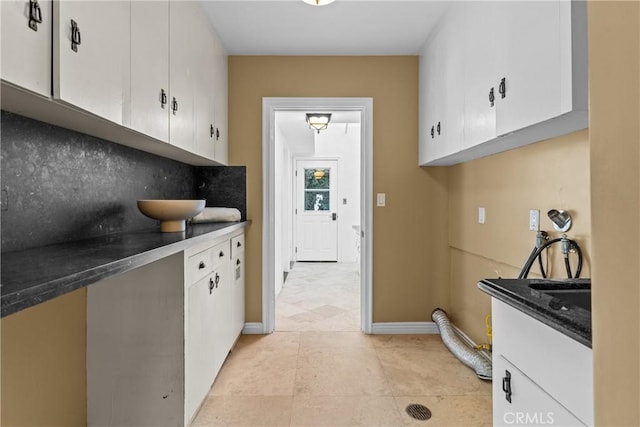 kitchen with backsplash and white cabinetry