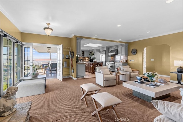 carpeted living room featuring plenty of natural light and crown molding