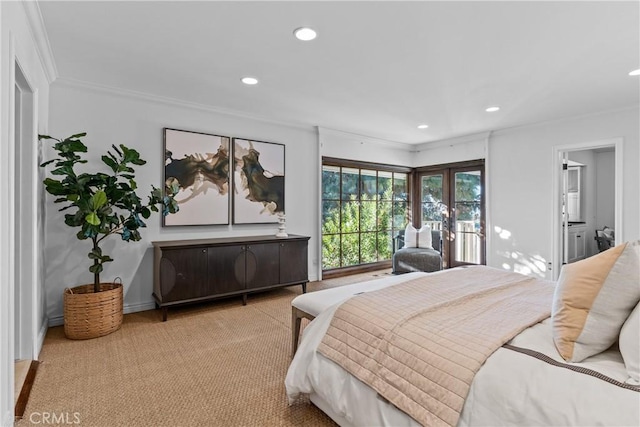 bedroom featuring light colored carpet, ensuite bathroom, and ornamental molding