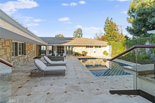 view of pool featuring an outdoor living space and a patio