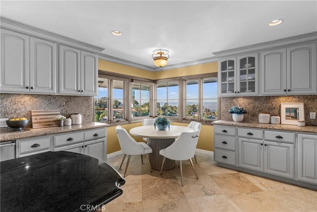 kitchen with decorative backsplash, gray cabinets, and crown molding