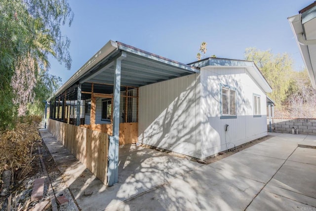 view of side of home featuring a carport