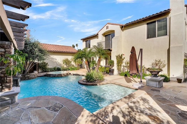 view of swimming pool featuring a patio area and an in ground hot tub