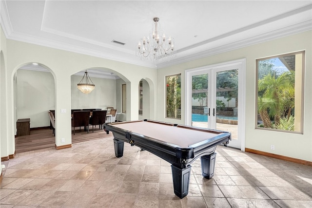 rec room featuring billiards, a raised ceiling, crown molding, an inviting chandelier, and french doors