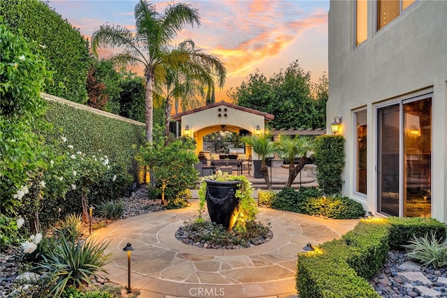 view of patio terrace at dusk