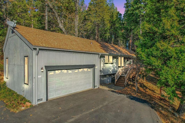 view of garage at dusk