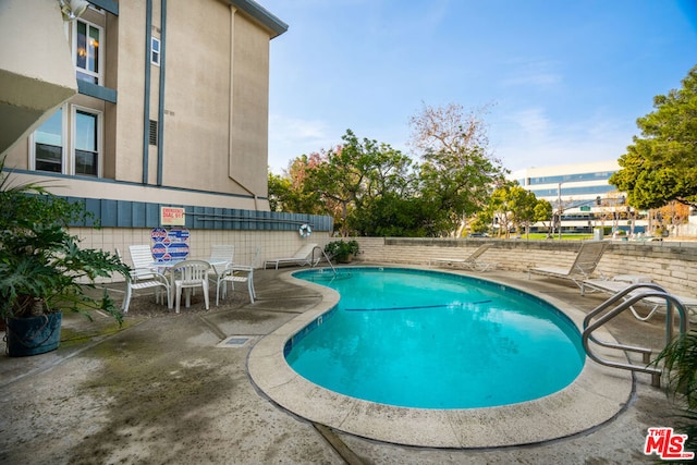 view of pool featuring a patio