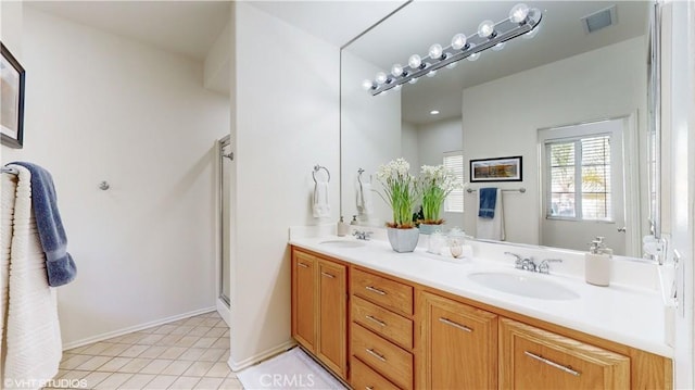 bathroom featuring an enclosed shower, vanity, and tile patterned flooring