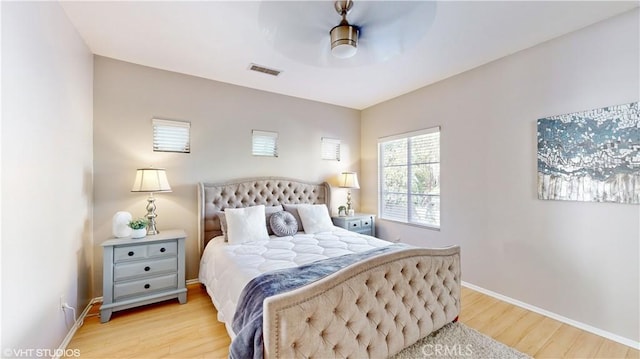 bedroom with ceiling fan and light hardwood / wood-style floors