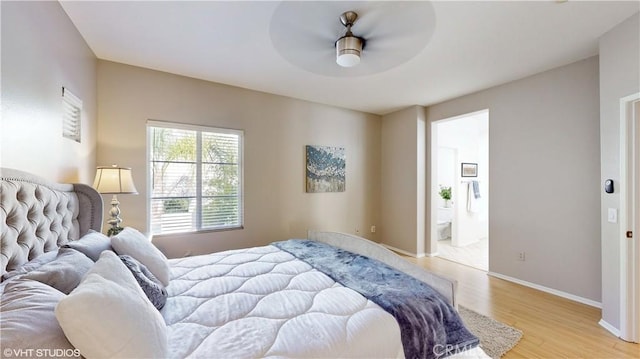 bedroom featuring ceiling fan, ensuite bathroom, and light hardwood / wood-style flooring