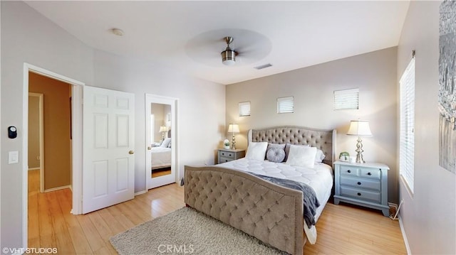 bedroom with ceiling fan and light wood-type flooring