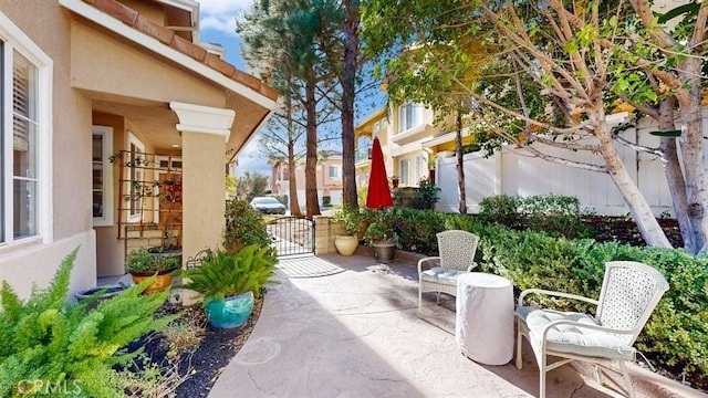 view of patio with a gate and fence