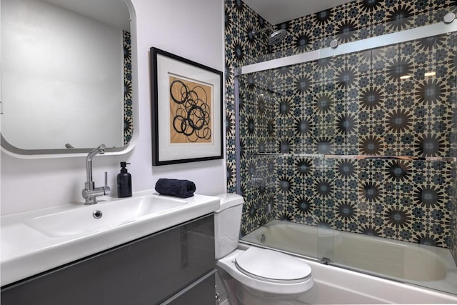 full bathroom with toilet, combined bath / shower with glass door, and vanity