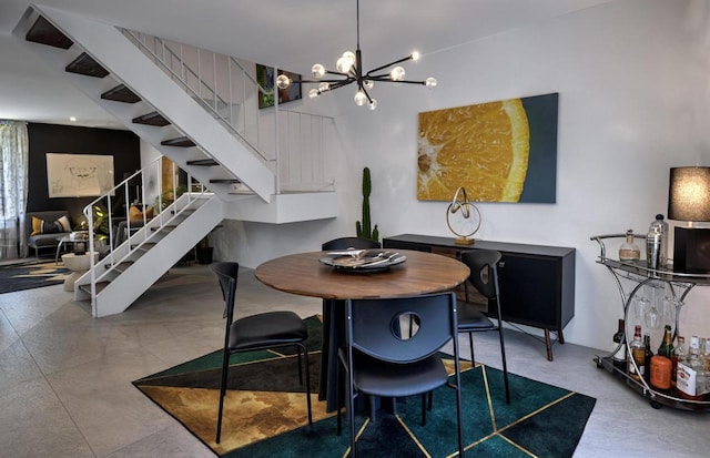 dining room featuring concrete flooring and an inviting chandelier