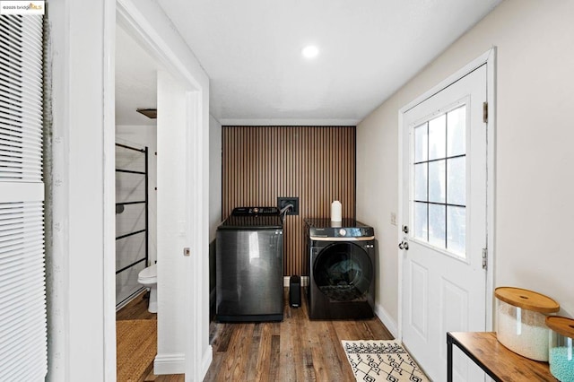 washroom featuring washing machine and dryer and dark hardwood / wood-style flooring