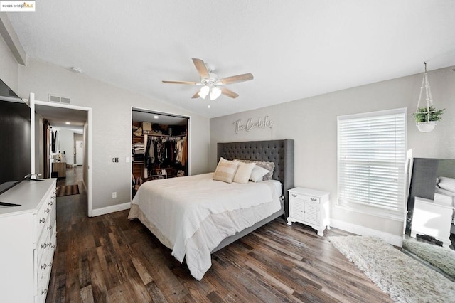 bedroom featuring lofted ceiling, dark hardwood / wood-style flooring, a spacious closet, ceiling fan, and a closet