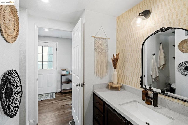 bathroom featuring vanity, toilet, and hardwood / wood-style floors