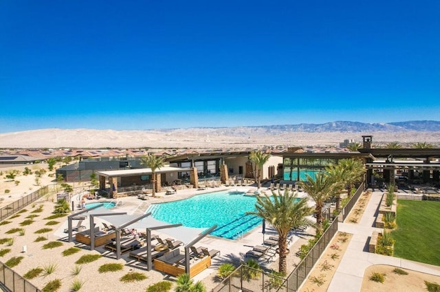 view of swimming pool with a mountain view and a patio