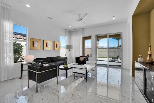 living room featuring a wealth of natural light and ceiling fan