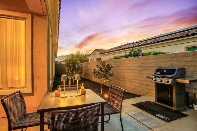 patio terrace at dusk with a grill