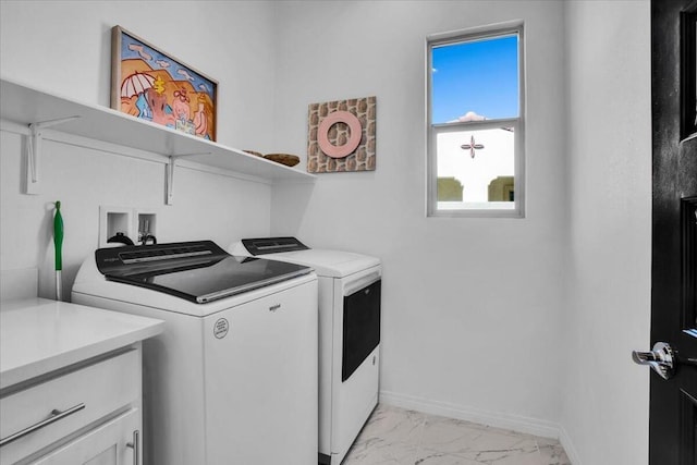 clothes washing area with washer and dryer