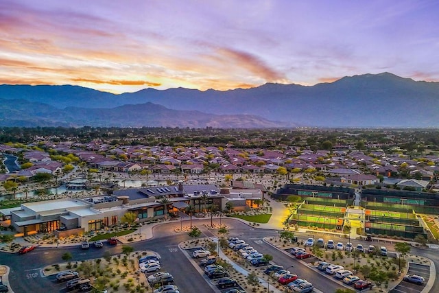 aerial view at dusk featuring a mountain view