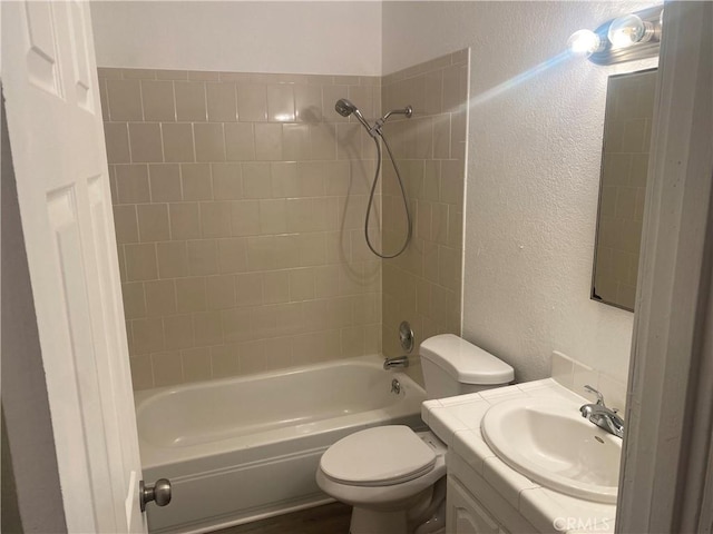 full bathroom with toilet, vanity, and shower / washtub combination