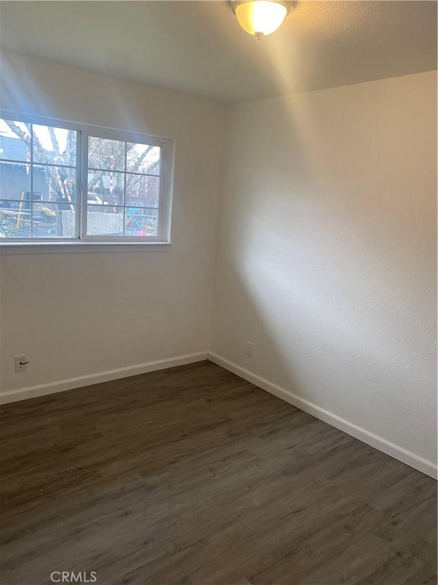 unfurnished room featuring dark hardwood / wood-style flooring