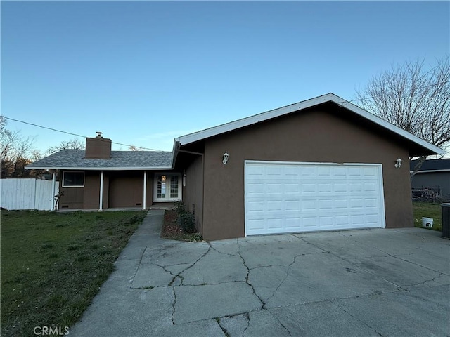 ranch-style home with a front lawn and a garage