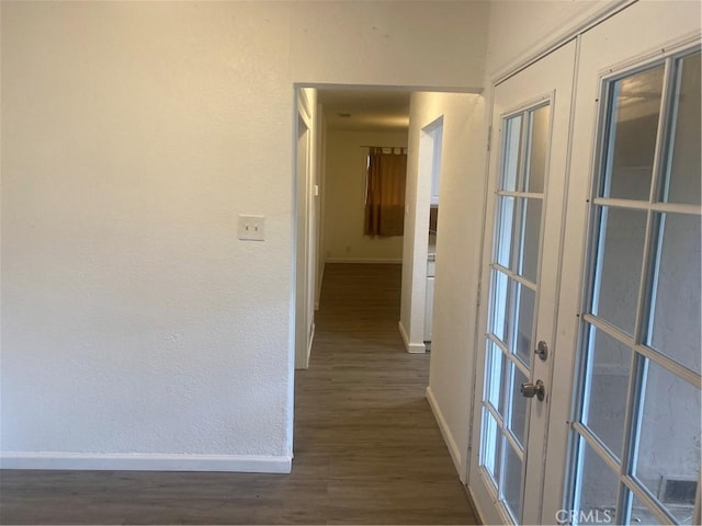 hall with french doors and dark hardwood / wood-style flooring