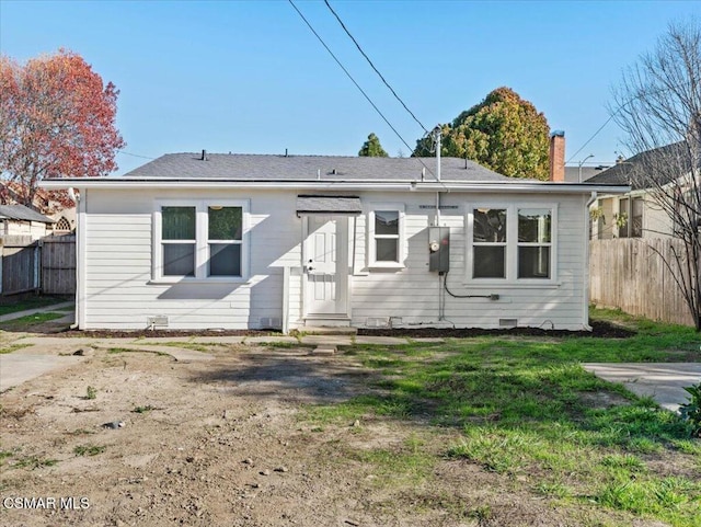 rear view of property with a lawn