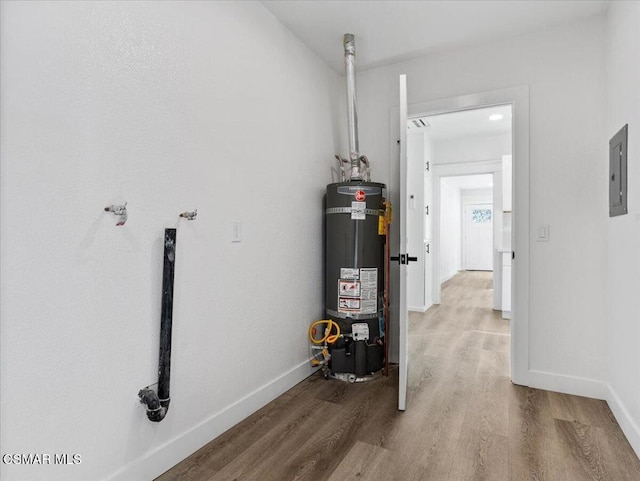 utility room with secured water heater and electric panel