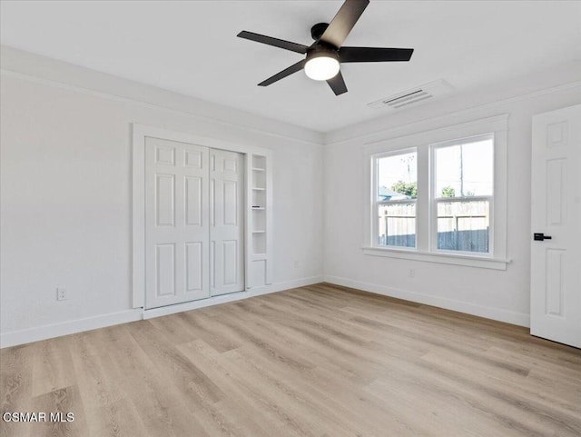 unfurnished bedroom with ceiling fan, a closet, and light hardwood / wood-style flooring