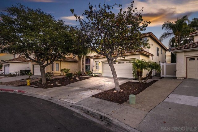 mediterranean / spanish-style house with a garage